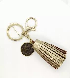 Metallic Gold vegan leather tassel keychain with Louis Vuitton Charm. Charm repurposed from LV Speedy 35 FH1912.