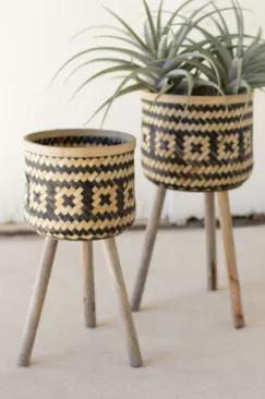 Hand-crafted from black and natural bamboo, our set of two planters with wooden legs will elevate your space. This duo will complement all of your beautiful greenery wherever you choose to place them!