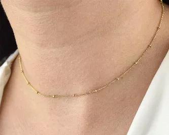 You have just found the dainty double chain gold filled necklace that has the power to make women feel:<br>
- chic and stylish; <br>
- feminine and elegant;<br>
- unique and fabulous.<br>
Product - details and features:<br>
- 16" necklace comes with 3" attached extender (16" - 19");<br>
- 14k Gold Filled 1mm satellite chain;<br>
- 14k Gold Filled wire wrapped details:<br>
- 14k Gold Filled spring ring closure;<br>
- handmade in California, USA.<br>
This elegant piece handcrafted with talented ha