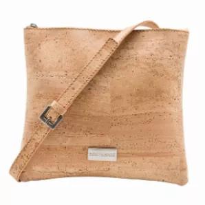 Handcrafted of 100% cork and lined with a soft 100% cotton backing. Features an adjustable strap for easy hands-free mobility. Spacious open interior with top zipper closure. Hardware: Matte Silver. 