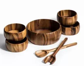 Beautiful large salad bowl comes complete with serving utensils and 4 matching individual salad bowls.  The perfect hostess, housewarming, or wedding gift.  Made from environmentally friendly Acacia wood.  Handcrafted from solid acacia wood, a high-quality hardwood great for culinary applications