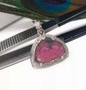 <p>Sterling Silver Natural Watermelon Tourmaline Slice Pave Diamond Pendant.</p> <p>** HANDMADE PENDANT**<br> SIZE : 26mm x 19.5mm x 6.5mm ( including Bail)<br> GEMSTONE : NATURAL PINK TOURMALINE SLICE<br> ORIGIN : AFGANISTHAN<br> TREATMENT : NO TREATMENT<br> METAL : 925 STERLING SILVER<br> DIAMOND WEIGHT : 0.31 CT's<br> DIAMOND COLOR. : I-J COLOR<br> DIAMOND : GENUINE DIAMONDS<br> SETTING : PAVE SETTING<br> **All Measurements are close approximations**</p> <p>This exclusive beautiful Handmade G