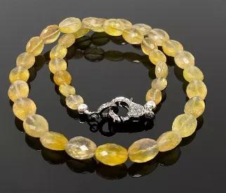 <p>Natural Yellow Sapphire Faceted AAA Quality Beaded Necklace with Genuine Pave Diamonds in the Clasp. </p> <p>SOLD AS = 16.5" NECKLACE ( Including Clasp)<br> BEAD SIZE. = 9x7mm - 14x 10mm<br> STONE = NATURAL YELLOW SAPPHIRE<br> ORIGIN = AFRICA<br> SHAPE = OVAL<br> GRADE = AAA GRADE</p> <p>CLASP = GENUINE PAVE DIAMOND LOBSTER CLASP ( Black Rhodium )<br> CLASP SIZE = 17.5mm x 11mm<br> METAL = .925 STERLING SILVER</p> <p>DIAMOND : CONFLICT FREE GENUINE DIAMONDS </p> <p>This Necklace is Handmade b