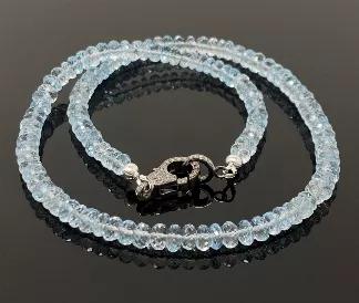 <p>Natural Blue Topaz AAA Quality Beaded Necklace with Genuine Pave Diamonds in the Clasp. </p> <p>SOLD AS = 16.85" NECKLACE ( Including Clasp)<br> BEAD SIZE. = 5.5mm - 6mm<br> STONE = NATURAL BLUE TOPAZ<br> SHAPE = RONDELLE<br> GRADE = AAA GRADE<br> CLASP = GENUINE PAVE DIAMOND LOBSTER CLASP ( Grayish Black Rhodium )<br> CLASP SIZE = 17.5mm x 11mm<br> METAL = .925 STERLING SILVER ( Black Rhodium Polish over Sterling Silver)</p> <p>DIAMOND : CONFLICT FREE GENUINE DIAMONDS </p> <p>This Necklace i