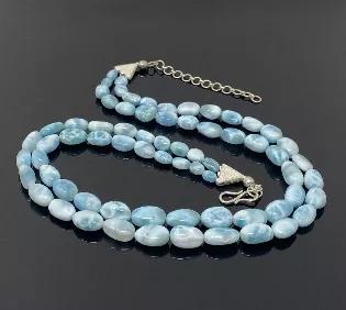 <p>Genuine Natural Dominican Republic Double Strand Larimar Gemstone Necklace .</p> <p>GEMSTONE : NATURAL GENUINE LARIMAR<br> ORIGIN. : DOMINICAN REPUBLIC<br> BEADS USED SMOOTH : YES<br> BEADS GRADE : AAA+ GRADE</p> <p>NECKLACE LENGTH : 21" Strand Length and 23" Strand Length ( including Triangle Link) Plus 3.5" Extender Chain<br> SIZE OF BEADS USED : 9mm x 6mm - 19mm x 14mm ( LxW - LxW)<br> TOTAL WEIGHT : 148g</p> <p>Larimar is the embodiment of the tranquil Sea and Sky energies. Its soft, soot