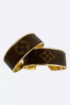 <p>Authentic Louis Vuitton material set in the channel of the gold plated bracelet. Approximately 3/4" wide. Lead and nickel free. Available in inspired Louis Vuitton with symmetrical placement. Please note either design will be supplied.</p> <p>Disclaimer: We are not affiliated with Louis Vuitton. We use the materials to create our designs. The logo and patterns are owned by Louis Vuitton and the subsidiaries.</p>