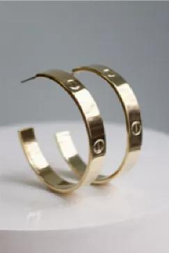 Classic designer inspired hoop earrings.1.5" diameter. 14K gold plate over brass or rhodium over brass. Available in gold and silver. Surgical steel post. Lead and nickel free. Made in the USA. <span> Please refrain from wearing in the ocean, pools, and hot tubs. Please wear after applying hairspray, perfumes, and other chemicals. </span>