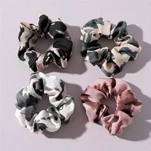 4 scrunchies in an animal print. 4" diameter. White/light gray, ivory/gray, beige/black, blush/brown.