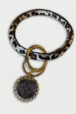 <span data-mce-fragment="1">Leopard wrist style keychain in vegan leather. The leopard pattern has a touch of metallic gold in the print. Complete with removable ring and keyring. Custom made charm made of authentic Louis Vuitton materials and set in a brass plate with clear crystals. Leopard ring is approximately 4" in diameter. </span>