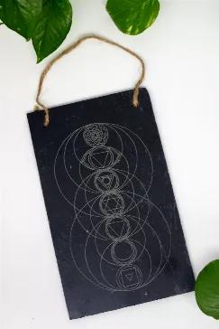 This gorgeous 10" by 6" engraved slate wall hanging features a delicate depiction of the Chakra system. We make these unique items here in Maryland!  



Chakra (cakra in Sanskrit) means "wheel" and refers to energy points in your body. They are thought to be spinning disks of energy that should stay "open" and aligned, as they correspond to bundles of nerves, major organs, and areas of our energetic body that affect our emotional and physical well-being.
