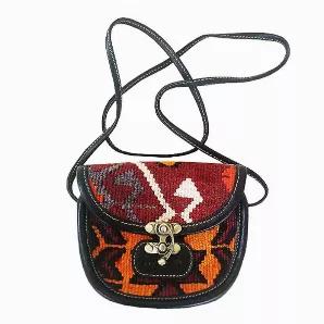 Type: Crossbody Bag (Messenger Bag) <br>
- Designed in Canada <br>
- Handmade in Turkey <br>
- Water Resistant <br>
Materials: <br>
- Handwoven Wool Kilim <br>
- Leather <br>
- Leather Strap <br>
Cleaning & Care: <br>
Cleaning of kilim products is similar to cleaning a Turkish rug: Use either a clean piece of sponge or cloth along with carpet shampoo. <br> *Additional photos are for shape and size reference. The bag for sale is the first two photos listed.