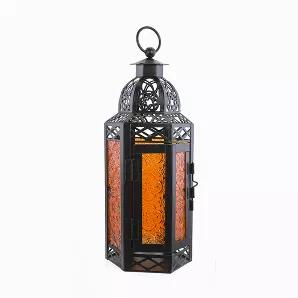Inspired by Moroccan Lounges and Turkish bazaars, this glass hanging lantern brings home a touch of the exotic to any home.  These decorative candle lanterns can be sued to create a romantic ambiance or to create a show stopping centerpiece.  Set the mood right with the flickering light of a candle and let the designs create the moody projections on your walls.  The crafted metal Moroccan Lanterns stands at over 11 inches tall and 4 inches wide, while the colored glass adds an extra color to any