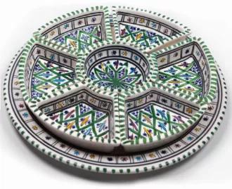 This Kamsah round shaped serving plate is the festive serving dish that you have been looking for! These unique handmade ceramic plates breaks into 7 little trays to serve appetizers and a larger big plate underneath. This might be used as a dipping dish, or as condiment serving dishes on which to put condiments/ nuts/ salsa & chips etc. It can also be used to hold jewelry or other small valuable charms. Each piece is made by local women for a fair wage in Neapolis, Tunisia, a city that's been m