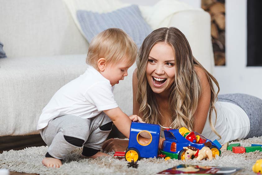 Woman plays with little boy